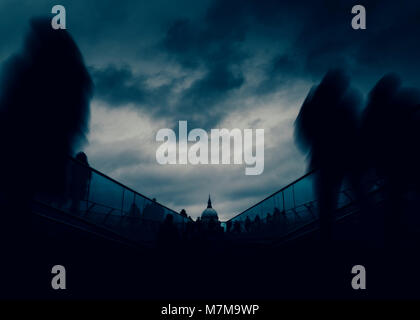 Long exposure of pedestrians at London, England, UK Millenium Bridge with St. Paul's Cathedral in background - dystopia dark post-apocalyptic fine art Stock Photo