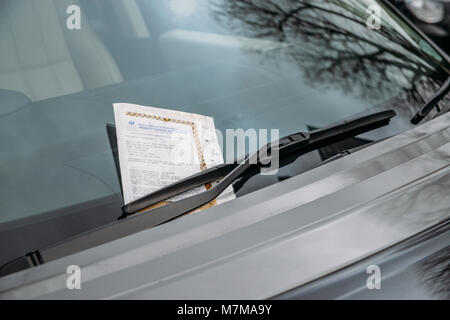 London, UK - March 10, 2018: Parking ticket stuck on car windscreen for a penalty or fine, captured in the Royal Borough of Kensington and Chelsea Stock Photo