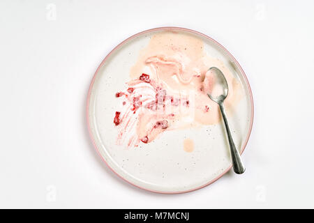 Top view of empty and dirty plate after raspberry ice cream has been eating Stock Photo