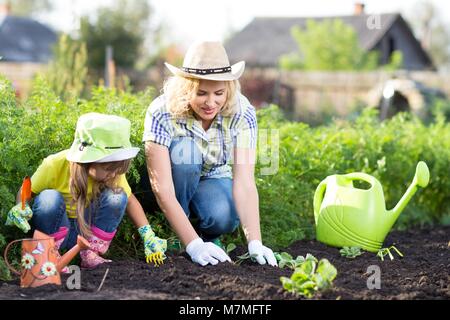 Mother and daughter engaged in gardening together Stock Photo