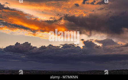 Beautiful yellow orange clouds on a blue sky after a thunderstorm Stock Photo
