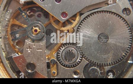 Clockwork. Gears, springs and other parts of the watch are visible. Macro mode. Stock Photo