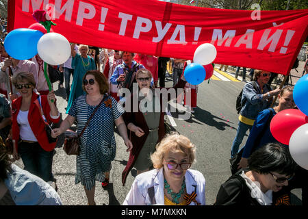 Participants in the May Day procession of the Communist Party are walking along Nakhimov square on the International Workers' Solidarity Day in Sevast Stock Photo