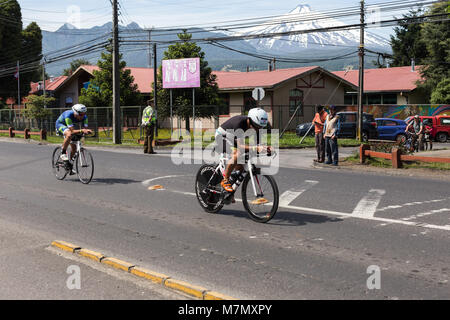 Athletes on their bikes passing through a town during Ironman 70.3 Pucon 2018 Stock Photo