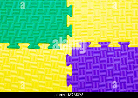 Close-up of baby playing mat background.  Jigsaw soft rubber surface texture. Foam floor children mat connection Stock Photo