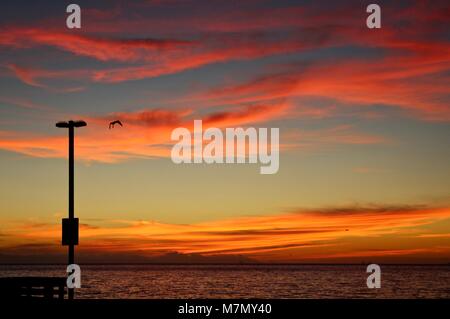 red sunset clouds over the pacific ocean Stock Photo