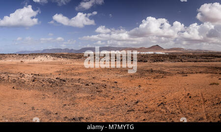Panorama of volcanic landscape on La Isleta, Lanzarote, Canary Islands with resort in the distance Stock Photo