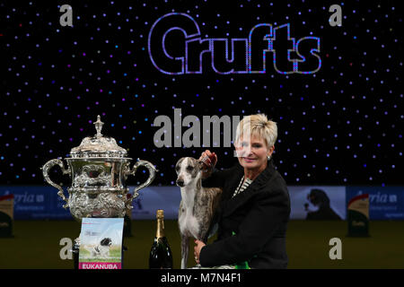 Tease, the Whippet, with owner Yvette Short after she was named Supreme Champion during the final day of Crufts 2018 at the NEC in Birmingham. Stock Photo