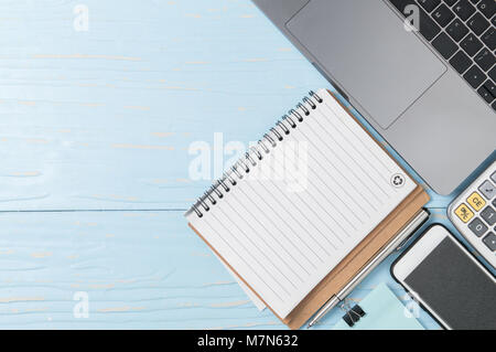 Blank note book and laptop with calculator on old wood background,  business concept and copy space Stock Photo