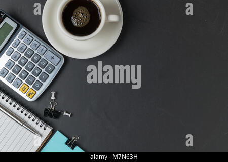 Office black stone desk table with calculator, black coffee and pen,  business background concept and copy space Stock Photo