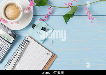 Blank note book and hot coffee with calculator on old wood background,  business concept and copy space Stock Photo