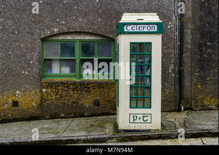 Old style Irish public telephone box telefon box in Castletownshend Village, West Cork, Ireland. Stock Photo