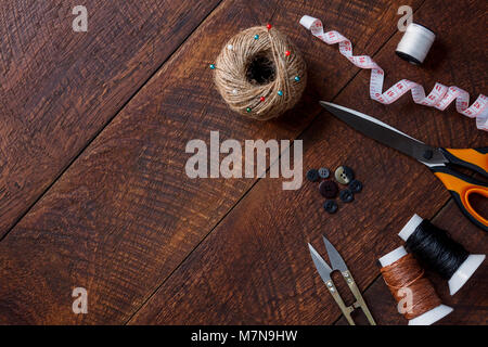 Top view aerial image fashion designer background concept.Flat lay sewing accessory or tailor tool work shop on modern rustic brown wooden at home off Stock Photo