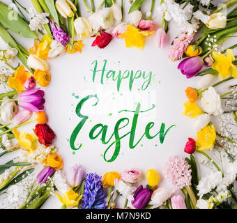 Happy Easter phrase and spring flat lay. Stock Photo