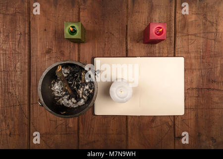 Overhead photo of cauldron, grimoire, and candles Stock Photo