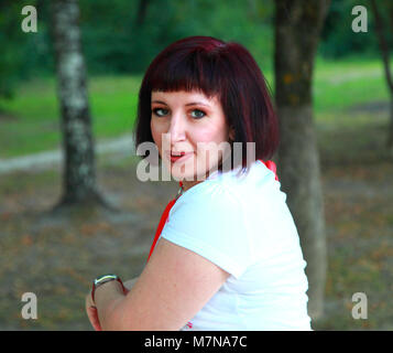 Portrait of a happy young girl in the woods on a summer day. Stock Photo