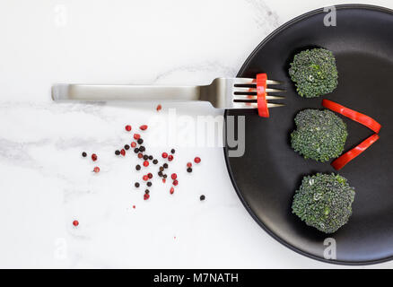 Fresh Broccoli on black plate Stock Photo