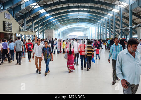MUMBAI, INDIA - JANUARY 2015: People walking through interior passageway at train station. Stock Photo