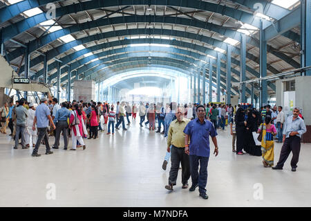 MUMBAI, INDIA - JANUARY 2015: Crowds walking through interior passageway at train station. Stock Photo