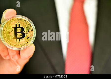 Unrecognizable person holding golden color bitcoin Stock Photo
