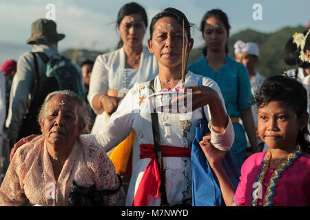 Bantul, Yogyakarta, Indonesia. 11th Mar, 2018. YOGYAKARTA, INDONESIA - MARCH 11 : Balinese Hindu pray during Melasti ceremony at Parangkusumo beach on March 11, 2018 in Yogyakart, Indonesia. Melasti is a Hindu Balinese purification ceremony and ritual, which according to Balinese calendar is held several days prior to the Nyepi holy day. Melasti was meant as the ritual to cleanse the world from all the filth of sin and bad karma, through the symbolic act of acquiring the Tirta Amerta, ''the water of life''.Melasti ceremony is held on the edge of the beach with the aim to purify oneself of a Stock Photo
