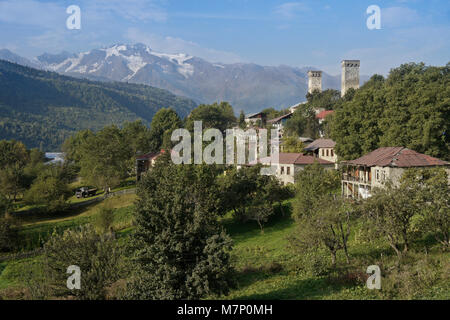 Historic tower houses stand amid more modern homes on a hillside in Mestia, Svaneti region of the Caucasus Mountains, Georgia Stock Photo