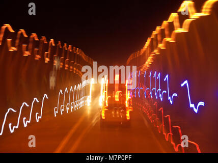 Slow-motion photograph of lights in a dark tunnel, taken from a moving vehicle Stock Photo