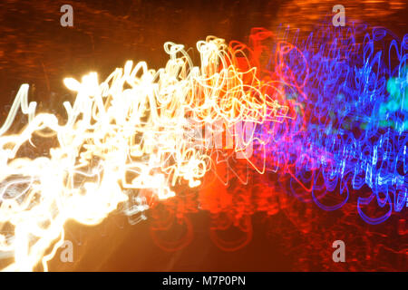 Slow-motion photograph of lights in a dark tunnel, taken from a moving vehicle Stock Photo
