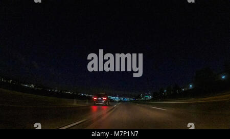 Driving on Interstate highway I25 at night. Stock Photo