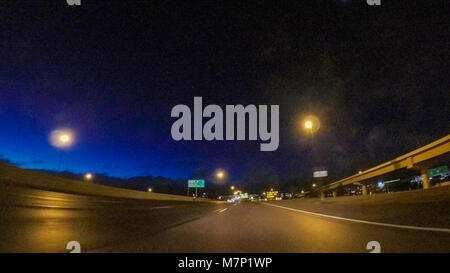 Driving on Interstate highway I25 at night. Stock Photo