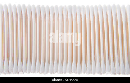 cotton swabs on sticks stacked and lined up in a row. Isolated on white background. commonly used in a variety of applications including first aid, co Stock Photo