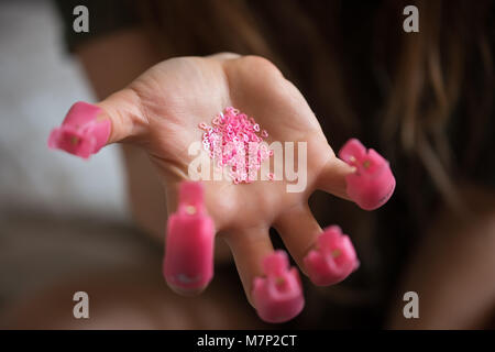 The procedure preparing varnish from nails. Plastic cover at nails Stock Photo