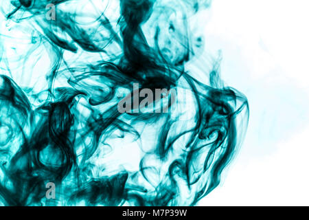 Dense multicolored smoke of green colors on a white isolated background. Background of smoke vape Stock Photo