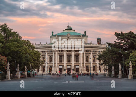 Long shot of Burgtheater in Vienna framed through the arch of Rathaus as the theatre lights come on Stock Photo