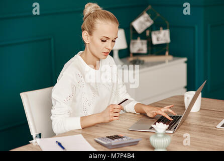 Woman doing online shopping at office Stock Photo