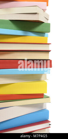 Vertical border or stack of colorful paperback books isolated on a white background.  Space for copy. Stock Photo