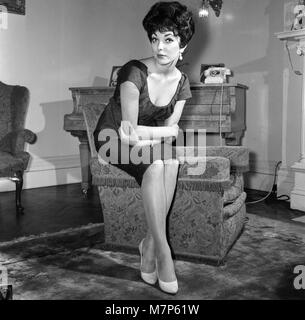 Film star Joan Collins flew into London today from Montego Bay, she is here to spend a few days with her family after which she will fly on to America. She is pictured at her parents flat in Regent's Park.  25th November 1958. Stock Photo