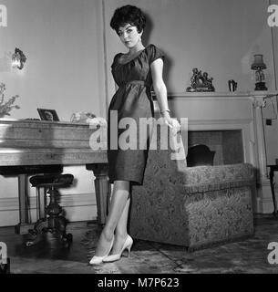 Film star Joan Collins flew into London today from Montego Bay, she is here to spend a few days with her family after which she will fly on to America. She is pictured at her parents flat in Regent's Park.  25th November 1958. Stock Photo