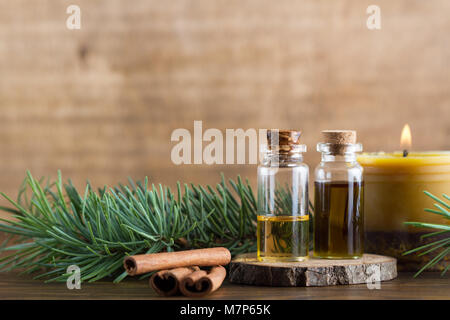 Essential oils, cinnamon stick and handmade beewax candle with cinnamon and essential oil Stock Photo