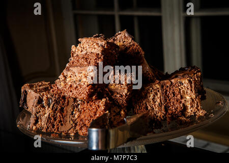 tasty sliced brownie cake served on stand for sweets Stock Photo