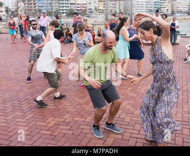 Swing Dancing outdoors overlooking city beach in Las Palmas on Gran Canaria, Canary Islands, Spain Stock Photo