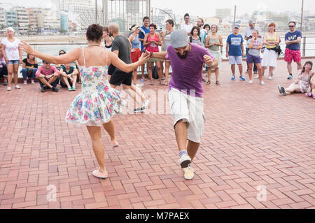 Swing Dancing outdoors overlooking city beach in Las Palmas on Gran Canaria, Canary Islands, Spain Stock Photo