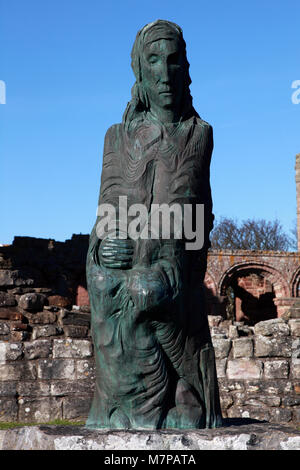 The statue of Saint Cuthbert by Fenwick Lawson placed at Lindisfarne Priory Church, Holy Island in 2001. Stock Photo