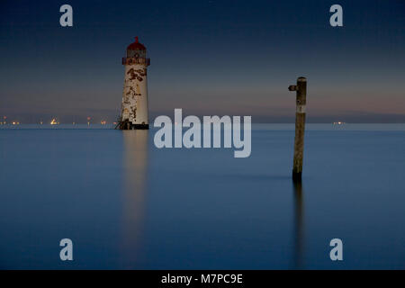 Point of Ayr lighthouse at night at high tide, Talacre on the North Wales coast Stock Photo