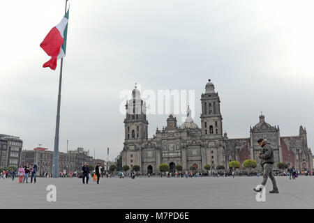 The vast zocalo square in Mexico City holds architectural treasures including the Mexico City Metropolitan Cathedral as shown in the background. Stock Photo