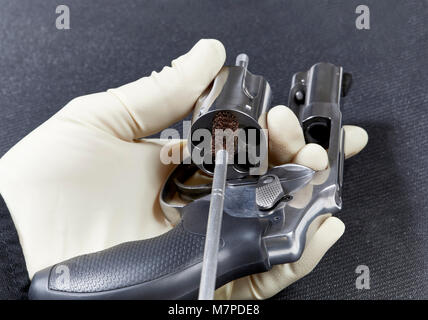 Cleaning the chamber of  a Revolver Stock Photo