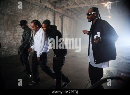 (L-R) 50 Cent, Ty Dolla Sign, YG and Snoop Dogg perform on-set at the 'Toot It & Boot It Remix' Music Video on November 18, 2010 in Los Angeles. Stock Photo