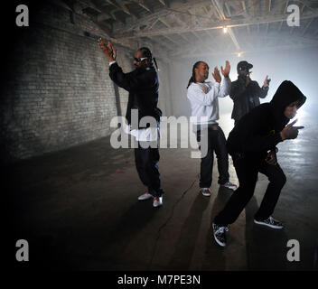 (L-R) Snoop Dogg, Ty Dolla Sign, 50 Cent and YG perform on-set at the 'Toot It & Boot It Remix' Music Video on November 18, 2010 in Los Angeles. Stock Photo