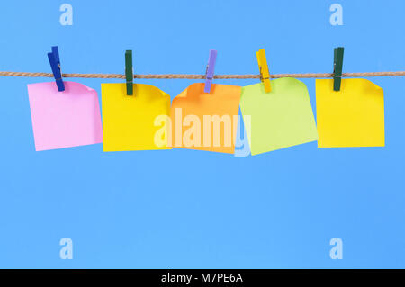 Blank office sticky notes hanging on a rope or washing line Stock Photo