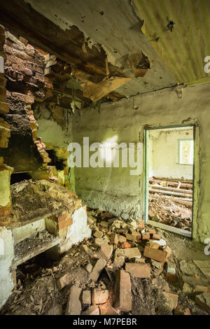 The Ruined Brick Oven Furnace In Abandoned Destroyed Country House In The Zone Of Nuclear Contamination After Chernobyl Disaster. Stock Photo